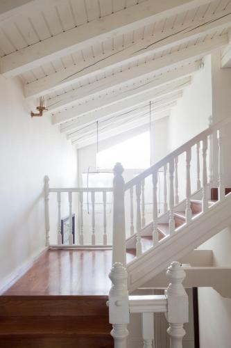 a staircase with white railings in a house at Hotel IRARAGORRI in Galdakao