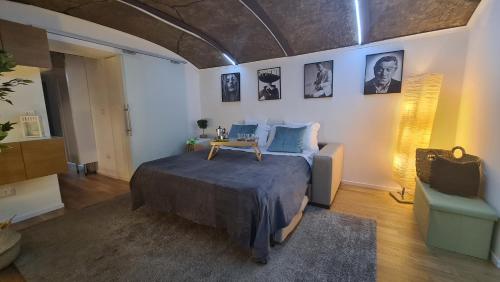 a bedroom with a bed with a table on it at La Foresteria in Caserta