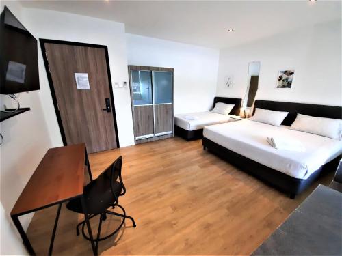 a hotel room with a bed and a desk at International Service Apartments at Raeburn Park in Singapore