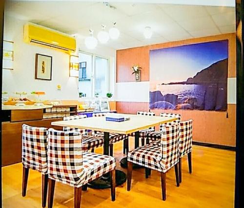a dining room with a table and chairs at Non-profit bee home in Keelung