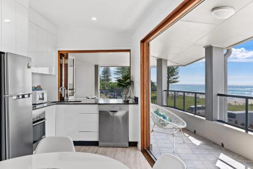a kitchen with a view of the ocean at Sea Salt - Lennox Head in Lennox Head