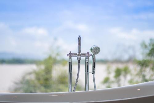 a group of three water faucets in a window at Siri regent Hotel in Nakhon Phanom