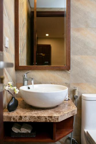 a bathroom with a white sink and a mirror at Midori Boutique Hotel in Hanoi