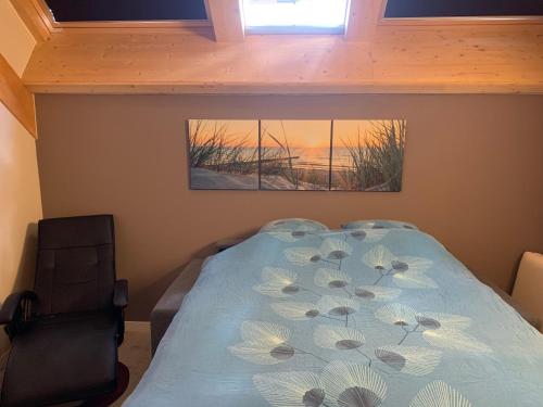 a bedroom with a bed and two pictures on the wall at Ecolodge Zen Otra Cosa in Mouscron