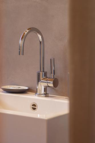 a bathroom sink with a silver faucet on it at Kronplatz LOFT Bruneck in Brunico