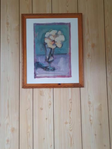a picture of a flower in a vase on a wall at Apollo Stay in Apollo Bay