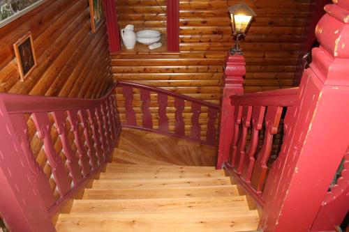 a spiral staircase in a house with wooden walls at Trunna Vandrarhem & Konferens in Orsa