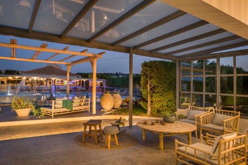 a pavilion with a table and chairs on a patio at Avithos Resort Hotel in Svoronata