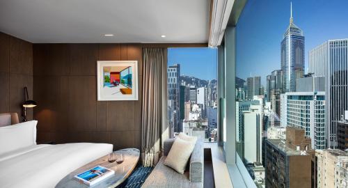 A bed or beds in a room at The Hari Hong Kong