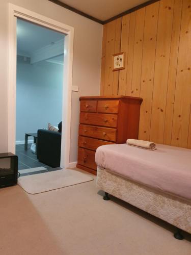 a bedroom with a bed and a dresser at Apollo Stay in Apollo Bay