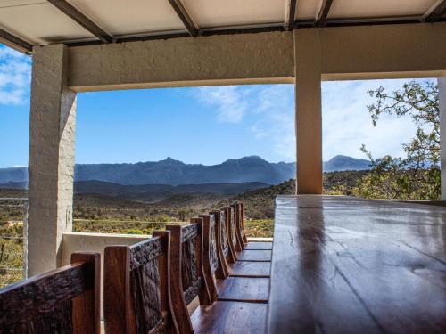 a table in a room with a view of the mountains at Rooiberg Wild Private Game Reserve in Ladismith