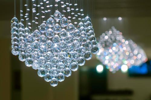 a bunch of crystals hanging from a chandelier at Golden Time Hotel in Braşov