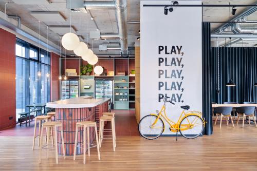 a yellow bike parked next to a bar in a room at STAYERY Bielefeld Hauptbahnhof in Bielefeld