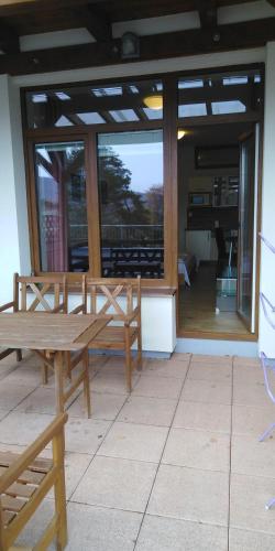 a wooden bench sitting on top of a patio at Aparthotel Rezidence Club Canada Lipno in Lipno nad Vltavou