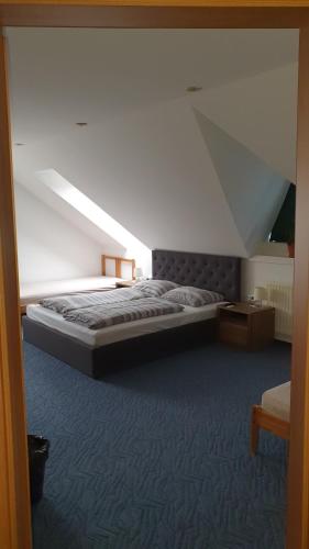 a bedroom with a bed with a sloped ceiling at Veszprém Room in Veszprém