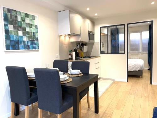 a kitchen and dining room with a table and chairs at Appart'Village Jouy Les Metz in Jouy-en-Josas