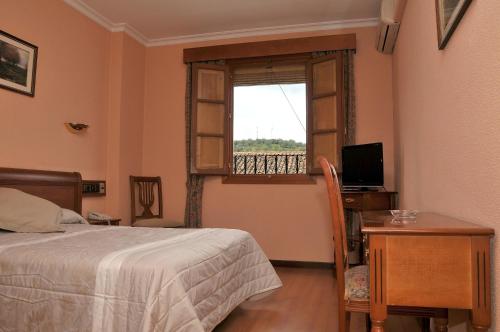 Postel nebo postele na pokoji v ubytování Hotel Los Castaños