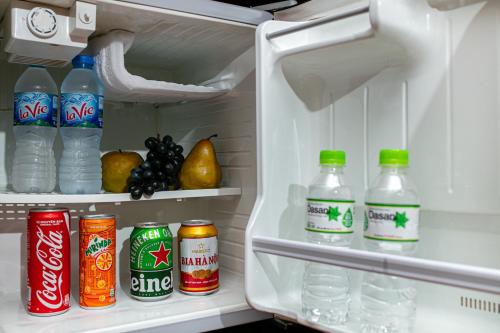 an open refrigerator filled with bottles of water and fruit at Midori Boutique Hotel in Hanoi
