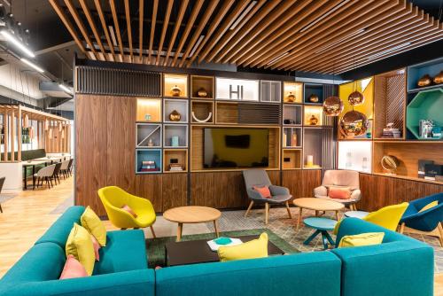 a living room with a blue couch and chairs at Holiday Inn Dover by IHG in Dover