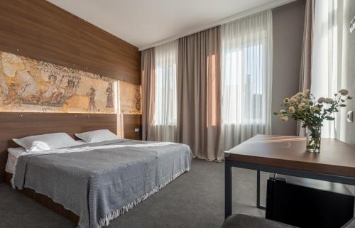 a hotel room with a bed and a desk at Hotel History • სასტუმრო ისტორია in Sighnaghi