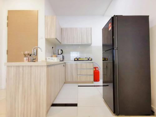 a kitchen with a stainless steel refrigerator at Skypod Residence Puchong in Puchong
