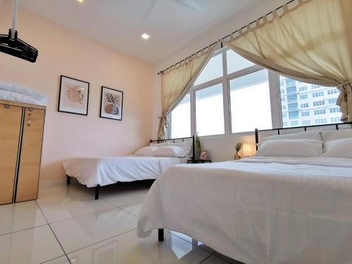 a bedroom with two beds and a large window at Skypod Residence Puchong in Puchong