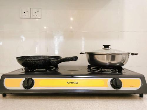 a pot and a pan on top of a stove at Skypod Residence Puchong in Puchong