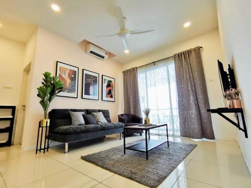 a living room with a couch and a table at Skypod Residence Puchong in Puchong