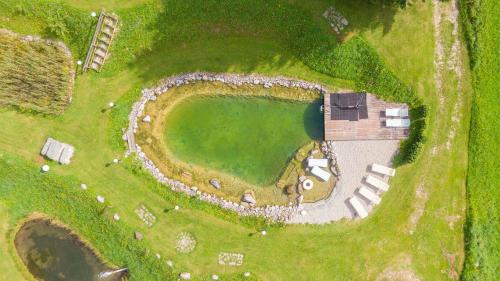 an aerial view of a golf course with a pool at Hotel Guesthouse Dalnig in Bad Kleinkirchheim