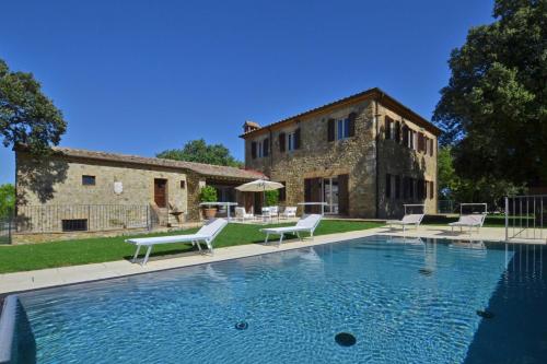 a large swimming pool in front of a building at Villa Paradiso in Mensano