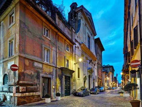 a city street with buildings and cars parked on the street at Hotel Indigo Rome - St. George by IHG in Rome