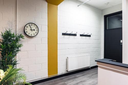 a clock on a wall next to a door at The DreamArt Warehouse in London
