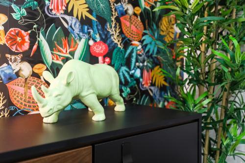 a white toy elephant sitting on top of a table at The DreamArt Warehouse in London