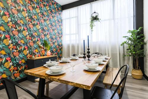 a dining room with a table and a floral wallpaper at The DreamArt Warehouse in London