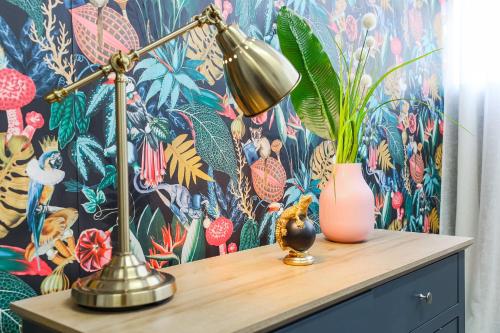 a desk with a lamp and a vase on it at The DreamArt Warehouse in London