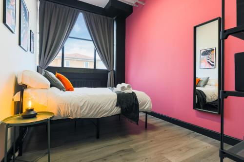 a bedroom with a bed and a mirror at The DreamArt Warehouse in London