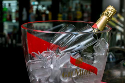 a bottle of champagne in a glass of ice at Hotel Apollo in Darłówko