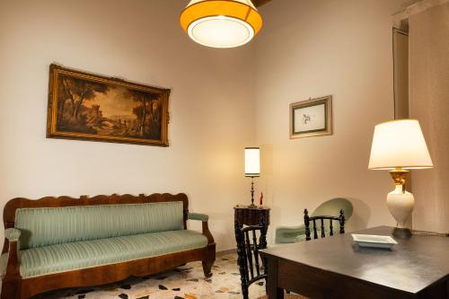 a living room with a couch and a table at Palazzo Benucci - Residenza di Charme in Santa Maria Capua Vetere