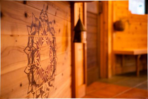 a wooden wall with a design on it at Ise Guest House Kazami in Ise
