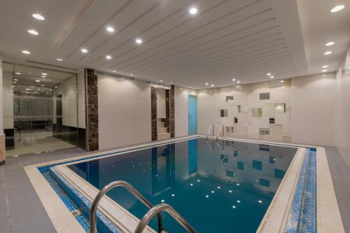 ein großes Schwimmbecken in einem Gebäude mit einem Schwimmbecken in der Unterkunft Iris Boutique Granada in Riad