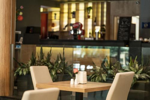a wooden table and chairs in a restaurant at HVD Club Bor Ultra All Inclusive - Private Beach & Free parking in Sunny Beach