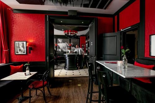 a bar in a restaurant with red walls at Le Theatre in Maastricht