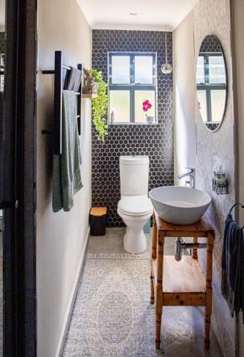 a bathroom with a toilet and a sink at Rest at Chabivin in Stellenbosch