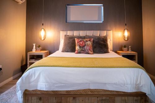 a bedroom with a large bed with two night stands at Rest at Chabivin in Stellenbosch