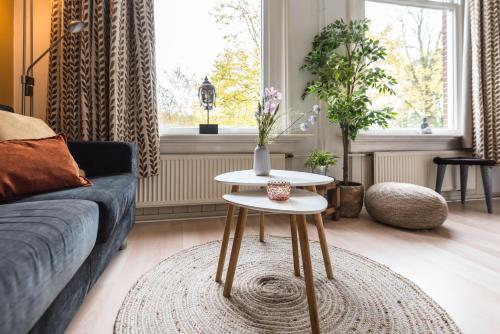 a living room with a couch and a table at Boutique Appartement-Hotel Villa Juttershof in Bergen