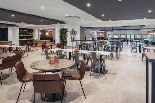 a restaurant with tables and chairs in a room at The Willows Training Centre in Wyboston