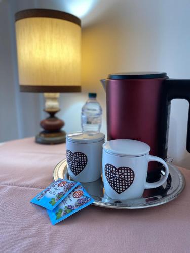 two coffee cups on a tray on a table at B&B Come a Casa in Citta' Sant'Angelo