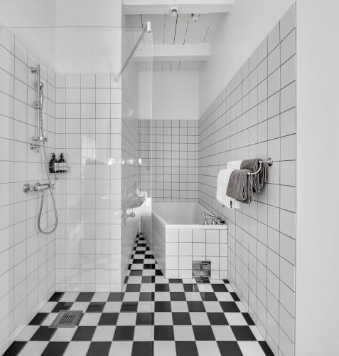 a bathroom with a black and white checkered floor at Boen Gård in Kristiansand