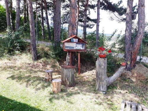 a bird house sitting on top of some trees at Вили Green in Tsigov Chark