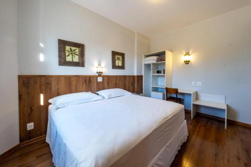 Tempat tidur dalam kamar di Beira Rio Palace Hotel
